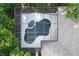 Aerial close up of the uniquely shaped screened in pool in the backyard at 5103 Twin Creeks Dr, Valrico, FL 33596