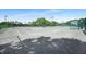 Well-maintained tennis courts with shade, seating, and green fencing in a lovely community at 5103 Twin Creeks Dr, Valrico, FL 33596