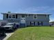 Charming blue two-story home with well-manicured lawn and white trimmed windows at 5111 Bay State Rd, Palmetto, FL 34221