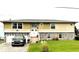 Charming two-story house with a unique stone base and a well-manicured lawn at 5111 Bay State Rd, Palmetto, FL 34221