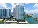 Beautiful exterior view of high-rise condos with tropical landscaping at 555 Quay Cmn # 1801, Sarasota, FL 34236