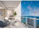 Large balcony with comfortable seating and dining area, providing stunning views of the ocean at 555 Quay Cmn # 2004, Sarasota, FL 34236