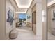 Elegant hallway with a large turtle artwork, wine fridge, recessed lighting, and an ocean view at the end at 555 Quay Cmn # 2004, Sarasota, FL 34236