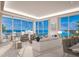 Spacious living room with modern decor, comfortable seating, and floor-to-ceiling windows showcasing the beautiful ocean views at 555 Quay Cmn # 2004, Sarasota, FL 34236