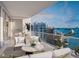 Spacious balcony with seating, an outdoor grill, and panoramic waterfront views at 555 Quay Commons # 1402, Sarasota, FL 34236