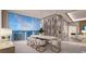 Elegant dining room with a marble table, wine storage, and scenic water views at 555 Quay Commons # 1402, Sarasota, FL 34236