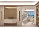 Sleek hallway with modern lighting and design, leading to a living area with water views at 555 Quay Commons # 1402, Sarasota, FL 34236