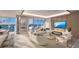 Bright living room featuring floor-to-ceiling windows, a fireplace, modern furniture, and beautiful water views at 555 Quay Commons # 1402, Sarasota, FL 34236