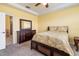 A well-lit bedroom with a floral comforter and easy access to the ensuite bathroom at 5609 Spanish Point Ct, Palmetto, FL 34221