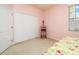 Comfortable bedroom with carpet, window and a bright pink wall at 5609 Spanish Point Ct, Palmetto, FL 34221