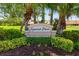 Community entrance sign for Spanish Point, surrounded by manicured landscaping and mature palm trees at 5609 Spanish Point Ct, Palmetto, FL 34221