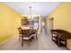 Bright dining area with tile flooring, chandelier, and a view into the kitchen at 5609 Spanish Point Ct, Palmetto, FL 34221