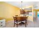 Dining area with dark wood table and views of kitchen, and ceramic tile floors at 5609 Spanish Point Ct, Palmetto, FL 34221