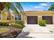 Charming home with well-maintained landscaping, a two-car garage, and a tile roof at 5609 Spanish Point Ct, Palmetto, FL 34221