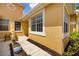 Exterior view of the home with lush landscaping, a walkway, and a tiled roof at 5609 Spanish Point Ct, Palmetto, FL 34221