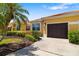 Charming home showcasing lush landscaping, a tile roof, and an attached garage at 5609 Spanish Point Ct, Palmetto, FL 34221