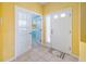 Inviting foyer with tiled floor, a decorative rug and doors to the office at 5609 Spanish Point Ct, Palmetto, FL 34221