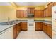 Functional kitchen with wooden cabinets, neutral countertops, and essential appliances at 5609 Spanish Point Ct, Palmetto, FL 34221