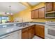 Open kitchen with a breakfast bar overlooking the living area, perfect for casual dining and entertaining at 5609 Spanish Point Ct, Palmetto, FL 34221