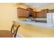 Bright kitchen with breakfast bar, offering casual seating, wooden cabinets, and essential appliances at 5609 Spanish Point Ct, Palmetto, FL 34221
