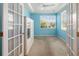 Bright office space with light blue walls, a ceiling fan, and natural light coming through the window at 5609 Spanish Point Ct, Palmetto, FL 34221