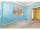 Bright office space with light blue walls and natural light coming through the window at 5609 Spanish Point Ct, Palmetto, FL 34221