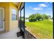 Enclosed patio featuring picturesque views of a grassy yard and serene lake at 5609 Spanish Point Ct, Palmetto, FL 34221