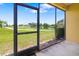 Screened-in patio boasts expansive views of the lush golf course and tranquil lake at 5609 Spanish Point Ct, Palmetto, FL 34221
