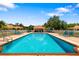 Community swimming pool with lounge chairs and a covered seating area for residents to enjoy at 5609 Spanish Point Ct, Palmetto, FL 34221