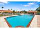 Community swimming pool with lounge chairs and lush landscaping for residents to enjoy at 5609 Spanish Point Ct, Palmetto, FL 34221