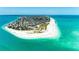 An overhead shot highlighting a residential area nestled along a beach with blue water and sandy shoreline at 5806 Gulf Dr # 201, Holmes Beach, FL 34217