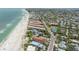 Expansive aerial view of beachfront property with beautiful shoreline, lush greenery, and vibrant community, near tennis courts at 5806 Gulf Dr # 201, Holmes Beach, FL 34217