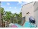 Balcony offers an outdoor relaxation area with seating and views of the surrounding lush tropical trees at 5806 Gulf Dr # 201, Holmes Beach, FL 34217