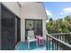 Cozy balcony with outdoor seating and a peek of lush greenery, perfect for relaxation at 5806 Gulf Dr # 201, Holmes Beach, FL 34217