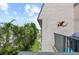 Charming balcony features seating with views of lush tropical trees and a glimpse of the serene beach at 5806 Gulf Dr # 201, Holmes Beach, FL 34217