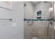 Modern bathroom features a spacious tiled shower with blue accent tiles and convenient grab bar at 5806 Gulf Dr # 201, Holmes Beach, FL 34217
