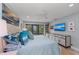 A bedroom with a king-size bed, ceiling fan, and large window for natural light at 5806 Gulf Dr # 201, Holmes Beach, FL 34217