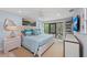 A bedroom with a king-size bed, ceiling fan, and large window for natural light at 5806 Gulf Dr # 201, Holmes Beach, FL 34217