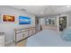 Bright bedroom with a modern dresser, large TV, and convenient access to a well-organized walk-in closet at 5806 Gulf Dr # 201, Holmes Beach, FL 34217