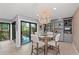 A stylish dining room area features a chandelier, built-in shelving and balcony access at 5806 Gulf Dr # 201, Holmes Beach, FL 34217