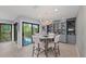 A stylish dining room area features a chandelier, built-in shelving and balcony access at 5806 Gulf Dr # 201, Holmes Beach, FL 34217