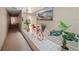 Hallway featuring coastal decor, a small red bicycle, and various potted plants creating a welcoming atmosphere at 5806 Gulf Dr # 201, Holmes Beach, FL 34217