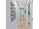 A long hallway featuring artwork on the wall leading to other rooms in the home at 5806 Gulf Dr # 201, Holmes Beach, FL 34217