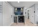 Hallway with open utility area that includes a wine fridge and front-loading washing machine at 5806 Gulf Dr # 201, Holmes Beach, FL 34217