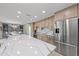 Kitchen area showcasing the island with quartz countertops, modern stainless appliances, and an open concept at 5806 Gulf Dr # 201, Holmes Beach, FL 34217