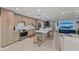 Open kitchen with island seating adjacent to the living room area at 5806 Gulf Dr # 201, Holmes Beach, FL 34217