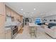 Open concept kitchen with an island, seating, stainless appliances, and an adjoining living area at 5806 Gulf Dr # 201, Holmes Beach, FL 34217