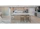 Well lit kitchen with island seating, stainless steel appliances, and a mini bar area at 5806 Gulf Dr # 201, Holmes Beach, FL 34217