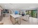 Bright, open-concept living room features a large island and comfortable seating with natural light at 5806 Gulf Dr # 201, Holmes Beach, FL 34217