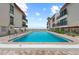 Community swimming pool with building views and a clear view of the ocean at 5806 Gulf Dr # 201, Holmes Beach, FL 34217